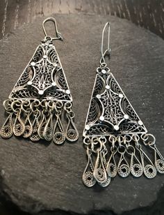 Apair of  sterling earrings--vintage hand wrought filigree long drop with fringe.  Condition I see no problems, marked 925 on backs.  I believe they are from the first half of the 1900s and either European, middle eastern or Egyptian.  Length 2 1/2", lots of interesting design and movement.  The time to design and form and soder all the parts is mind blowing-I've done studio unique pieces in silver over the years seeing this design and its execution leaves much to be appreciated by the skilled artist that made them.  They will move like rain when worn. Antique Filigree Chandelier Drop Earrings, Ornate Sterling Silver Chandelier Earrings, Antique Chandelier Earrings With Intricate Design, Vintage Sterling Silver Chandelier Dangle Earrings, Vintage Sterling Silver Dangle Chandelier Earrings, Vintage Silver Chandelier Earrings, Ornate Chandelier Earrings, Silver Dangle Chandelier Earrings With Intricate Design, Vintage Pierced Chandelier Earrings