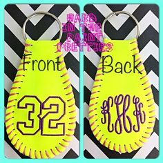 two softball keychains with the numbers 22 and 23 on them, one is neon yellow