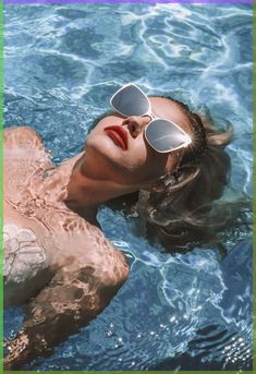 a woman wearing sunglasses floating in the water