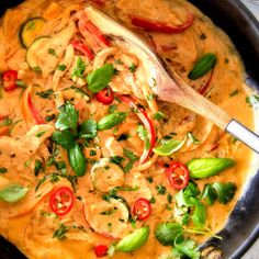 a skillet filled with shrimp and vegetables