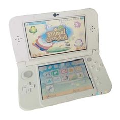 an animal crossing game system sitting on top of a white tablet pc case with its screen open