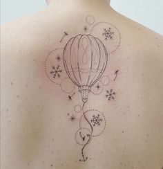 the back of a woman's shoulder with a hot air balloon tattoo on it