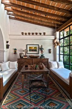 a living room filled with furniture and lots of windows