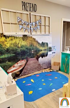 a room that has a large painting on the wall and a boat in the water