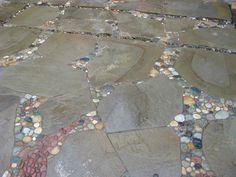 a stone walkway with pebbles and stones on it