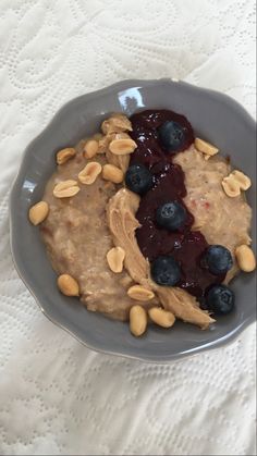 a bowl filled with oatmeal and blueberries on top of a table