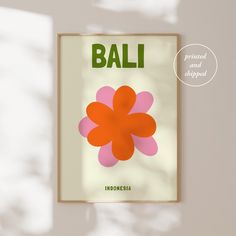 a poster with the word bali printed and shipped on it's back side in front of a white wall