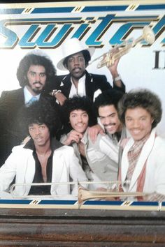 a group of men in white suits and ties posing for a photo on the cover of an album