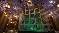 the interior of a building with lots of purple flowers hanging from it's ceiling