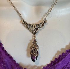 Here is one of my favorite fancy Art Nouveau style necklaces. It has a fancy bright bronze Nouveau style bib lavalier with a piece of purple Czech glass stone wrapped in a shiny solid brass floral setting a la SO Art Nouveau.  The color is a bit darker than the dress in my photos. It's delicate and not too over the top so it would be pretty with any outfit. As you can see in the photos, you can wear it any length so it's longer (18") or shorter more like a choker/bib. Czech glass is an alternati Elegant Bronze Collectible Necklace, Elegant Decorative Brass Necklaces, Elegant Brass Necklaces With Decorative Details, Nickel-free Metal Victorian Necklace, Elegant Bronze Wire Wrapped Necklaces, Elegant Pewter Necklace As Gift, Elegant Pewter Necklace As A Gift, Elegant Pewter Necklace For Gift, Elegant Pewter Necklace In Antique Silver