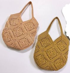 two crocheted purses sitting next to each other on a white table top