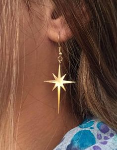 Gold plating or Silver 925 Star Earrings, designed as the star of Bethlehem, which makes them also a perfect Christmas gift. Star Long Dangle Earrings made of 14 karat gold plated brass or strling silver. These unique long dangle earrings feature beautiful matte gold plated over brass star dangling from ear wire. Chic and stylish earrings! These earrings measure approx 35/22 mm from the top of the star to the bottom of the star. Celestial Earrings Gold, Drop Star Earrings, Star Burst Earrings, Golden Sun Earrings, Sun Dangle Earrings, Gold Star Earrings Dangle, Gold Star Jewelry Aesthetic, Star Shaped Jewelry, Gold Star Accessories