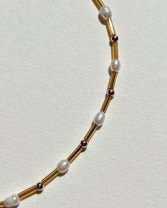 A lighter version of our classic choker. Golden glass mini beads, gold plated beads, and freshwater pearls. Choker lite is 13 inches long plus a 2-inch extension chain made of gold plated stainless steel and gold plated stainless steel lobster clasp. Hand-made by Karo at her home in Los Angeles. Handle with care. Gold Beaded Chain Pearl Choker, Gold Beaded Pearl Charm Choker Necklace, Gold Beaded Choker Necklaces With Pearl Charm, Gold Beaded Choker Necklace With Pearl Charm, Gold Beaded Necklace With Pearl Chain For Everyday, Everyday Gold Beaded Necklace With Pearl Chain, Everyday Gold Beaded Necklaces With Pearl Charm, Everyday Gold Pearl Necklace With Tiny Beads, Adjustable Gold Choker With Pearl Drop