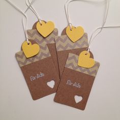 two brown tags with yellow hearts on them