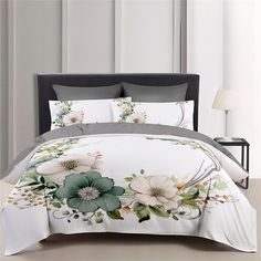 a bed with white and green flowers on it