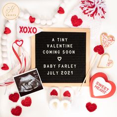 a tiny valentine's day sign is surrounded by other decorations and items for the baby