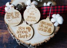 wooden ornaments with sayings on them sitting on a piece of wood