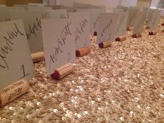 there are five wine corks on the table with paper signs in front of them