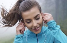 a young woman listening to music with headphones