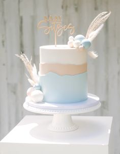 a blue and white cake sitting on top of a table