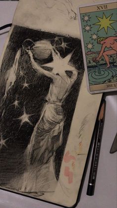 a pencil drawing of a woman with stars on her body next to a tarot card