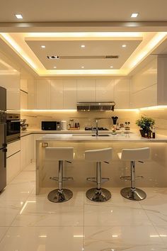 a kitchen with two stools in front of the counter and an oven on the other side