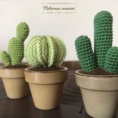 three crocheted cactus plants sitting in small pots