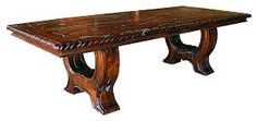 a wooden table with an intricate design on the top and bottom, against a white background