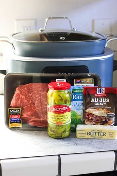 the ingredients for this meal are displayed in front of an open crock pot on top of a counter