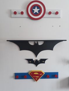 the batman and superman symbol are hanging on the wall