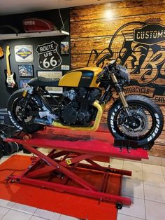 a yellow motorcycle is on display in a shop