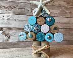 a christmas tree made out of wine corks with starfish and seashells