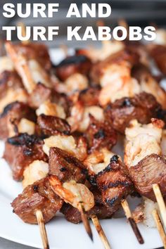 several skewers of meat are on a white plate with toothpicks sticking out of them