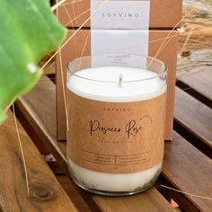 a candle sitting on top of a wooden table next to a box with a label