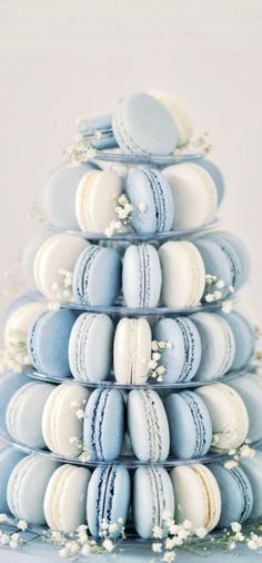 blue and white macaroons stacked on top of each other in the shape of a pyramid