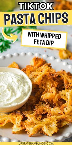 a white plate topped with fried food next to a bowl of dip