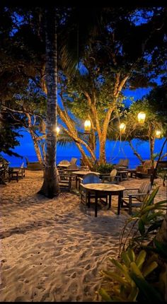 an outdoor dining area on the beach at night