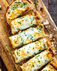 slices of bread with cheese and herbs on a cutting board