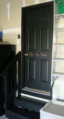 a black door with writing on it in a room