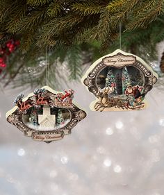 two ornaments hanging from a christmas tree