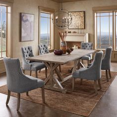 a dining room table with chairs and a chandelier