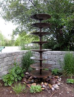 a water fountain in the middle of a garden