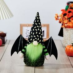 a green and black halloween decoration sitting on top of a wooden table