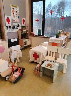 a room filled with lots of white furniture and red crosses on the windowsills