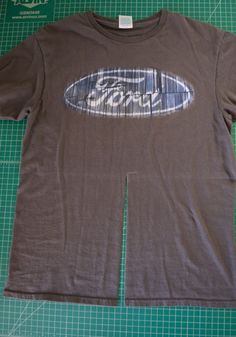 a brown t - shirt with an image of a surfboard on it