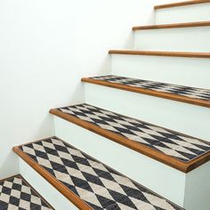 the stairs are decorated with black and white checkered carpet