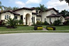 a large house with lots of trees and bushes