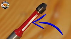 a close up of a screwdriver with an arrow pointing towards it