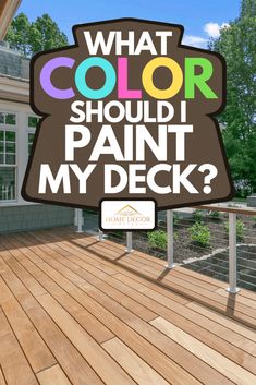 a sign that says what color should i paint my deck? in front of a house