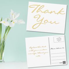 a vase filled with white flowers next to a thank card